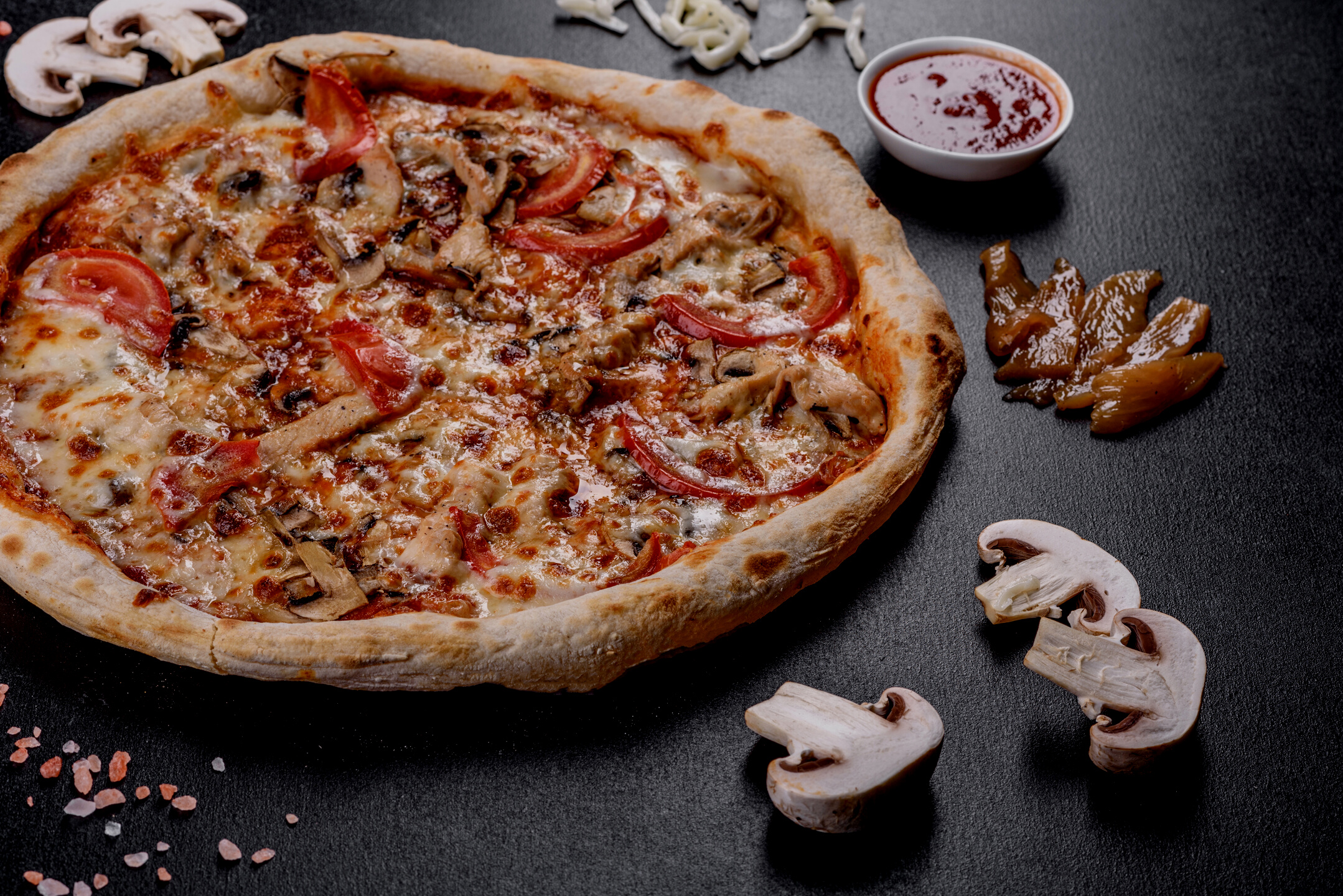 Fresh Delicious Italian Pizza with Mushrooms and Tomatoes on a Dark Concrete Background